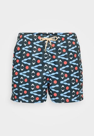 Un short de bain à motifs avec un fond bleu marine et des formes de vagues bleues, des yeux noirs et des points rouges. Comprend une taille élastique avec un cordon de serrage.