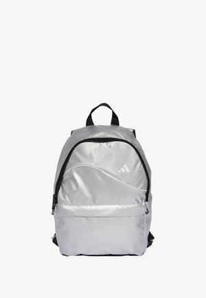 Silver backpack made of smooth, reflective material. Features a black zipper, logo, and a front pocket with a curved design. Adjustable straps.
