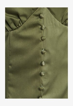 Olivroheline satiinriietus, millel on istuv korpus, kuue kangaga kaetud nupuga ja kogutud tekstuur ühelt küljelt.