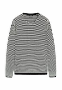 Maglietta a maniche lunghe a righe bianche e nere, con scollatura rotonda e polsini a coste. Tessuto liscio con orlo nero a contrasto.