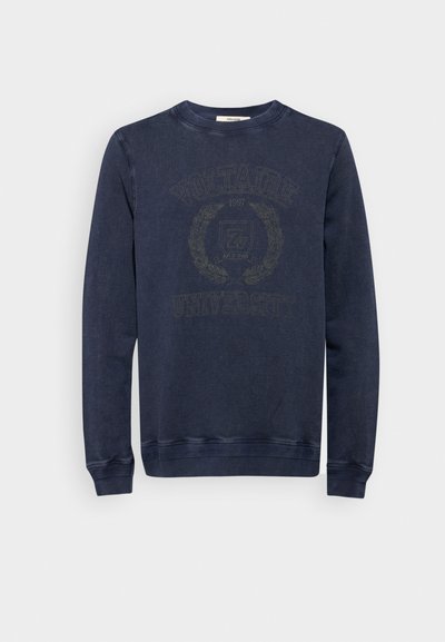 Navy blue sweatshirt made of cotton, featuring a round neckline, ribbed cuffs, and a central graphic with "Voltaire University 1997" design.
