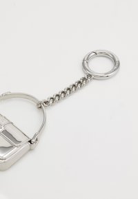 Silver keychain with a rectangular charm, featuring a polished metal finish, a chain link attachment, and a ring for connecting items.