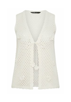 Gilet senza maniche in crochet bianco con bordi smerlati, applicazioni floreali e chiusura frontale con laccetti.