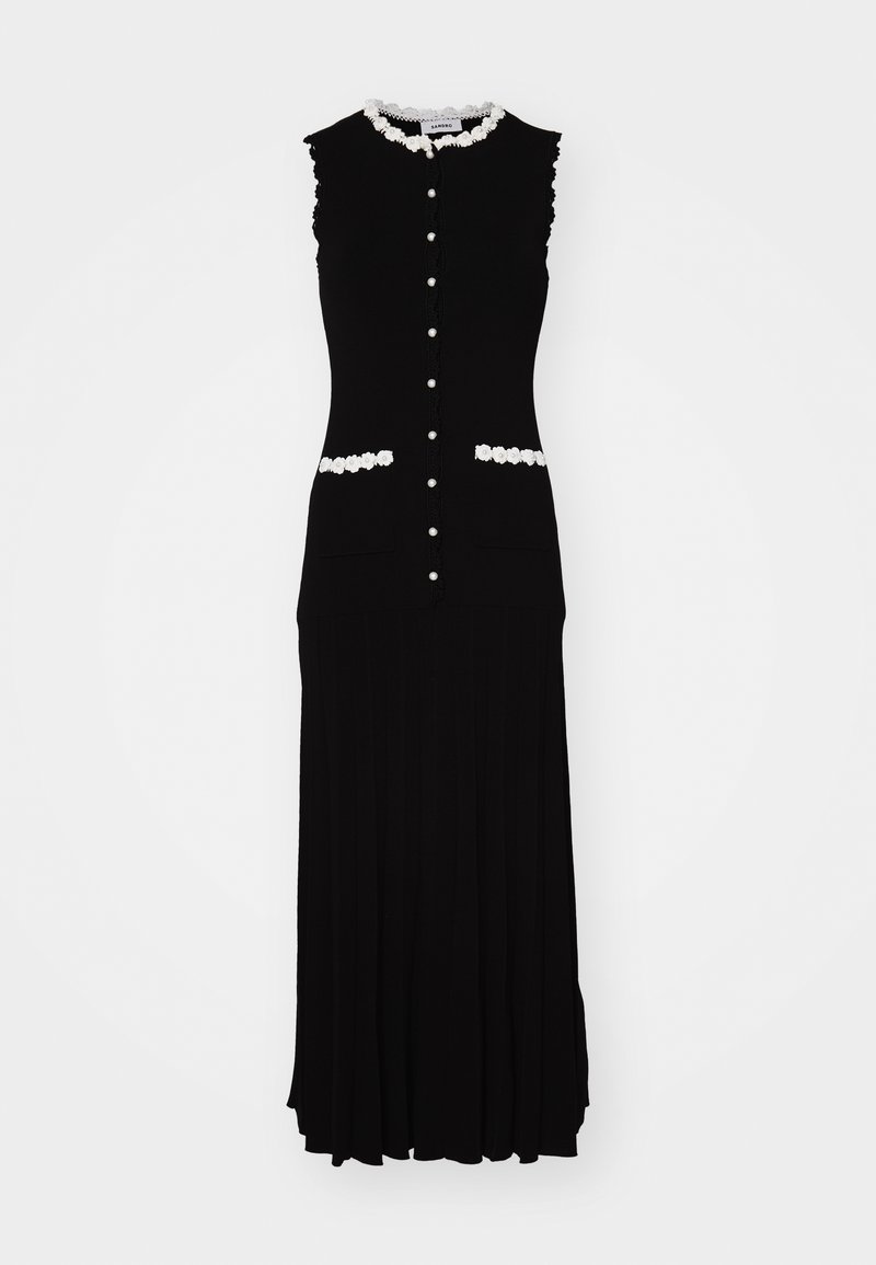 Schwarzes ärmelloses Kleid mit tailliertem Oberteil, weißem Blumenbesatz und Knöpfen. Verfügt über zwei Vorderentaschen und ein plissiertes Rockdesign.