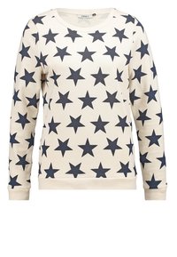 Sudadera crema con un patrón repetido de estrellas azul oscuro, cuello redondo, mangas largas y un dobladillo acanalado sólido.