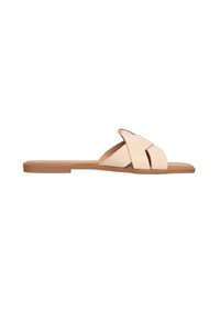 Sandale en cuir beige à tiges entrecroisées, semelle plate et détails cousus ; design minimal, texture lisse.