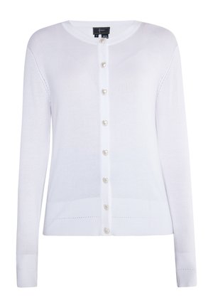 Balta megzta kardiganas su ilgomis rankovėmis, apvaliu kaklu ir širdelės formos sagomis. Turintis raštuotas rankogalius ir subtilų tekstūrinį raštą.