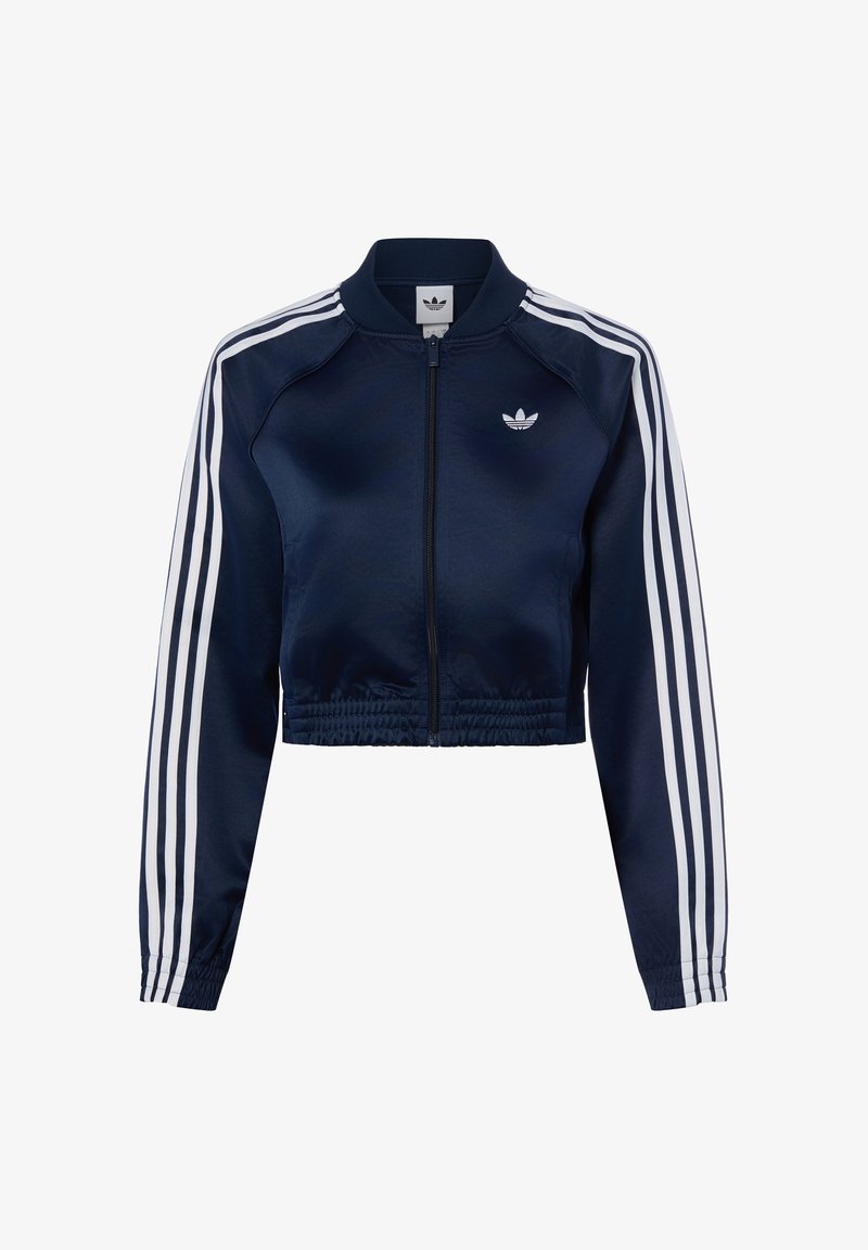 Marineblaue, cropped Zip-Up-Jacke mit weißen Drei-Streifen-Details an den Ärmeln und kleinem weißen Adidas-Logo auf der Brust.