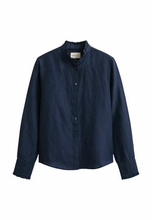 Marineblaue Langarm-Bluse mit Knopfleiste, kleinem Stehkragen und Rüscheneinfassung am Kragen und an den Manschetten.