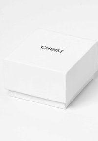 Weißer quadratischer Schmuckkasten mit glatter Oberfläche und erhöhtem Deckel. Das Wort "CHRIST" ist in Schwarz, zentriert auf der Oberseite gedruckt.