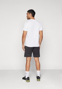 Puma FORM SEAMLESS 7 - Športové šortky - black/white cat
