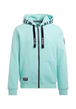 Helles blaues Zip-Hoodie mit einem verstellbaren Kapuzenzug, zwei Vordertaschen, gerippten Bündchen und einem Logo-Patch auf der linken unteren Seite.