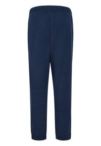 Marinblå fleecebyxor med elastisk midja, smal passform och elastiska manschetter vid anklarna. Mjuk textur, inga synliga mönster eller hårdvara.
