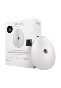 Rafraîchisseur d'hydratation faciale au design ovale. Plastique blanc avec un accent rose doré et un bouton de contrôle. Livré dans une boîte blanche avec un logo.