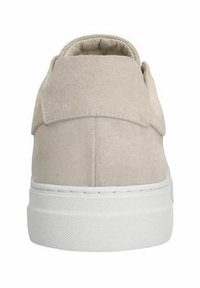 Beige suede sneaker with a rounded shape, featuring a padded collar and white rubber sole, textured lace area, and subtle stitching details.