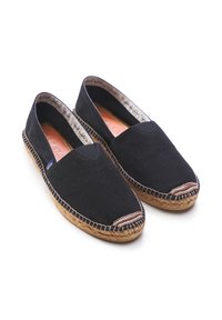 Black canvas espadrilles with a jute sole. Features a closed toe design, contrasting trim, and a soft interior lining.