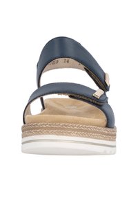 Blue leather sandal with two adjustable straps, padded suede insole, woven jute-like midsole, and white rubber outsole.