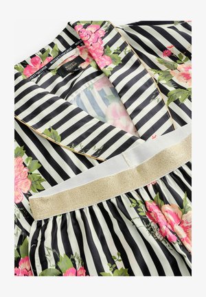 Floral-patterned pajama top with black and white stripes, featuring a gold-accented waistband and a silky texture.