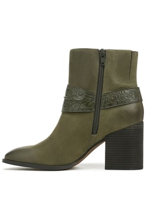 Olive green leather ankle boot with textured embossed detail and side zipper. Features a block heel with a ribbed design for stability.