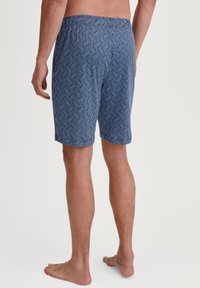 Zwemshorts van geweven stof, met een geometrisch patroon in navy en wit, elastische tailleband en een ontspannen pasvorm.