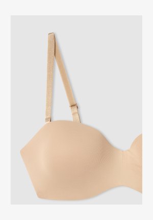 Reggiseno beige senza cuciture con tessuto morbido, coppe modellate e spalline sottili e regolabili in satin. Presenta una leggera lucentezza e una chiusura a gancio.