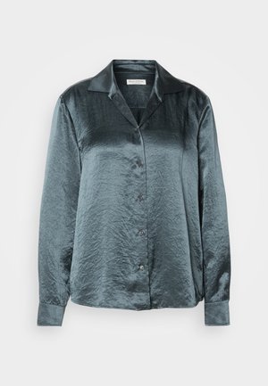 Tumman teal-sateeninen pitkähihainen paita, jossa on kaulus, napitettava etuosa, sileä rakenne ja kevyt kiilto. Paidassa on viisi nappia ja hihansuissa on cuffit.