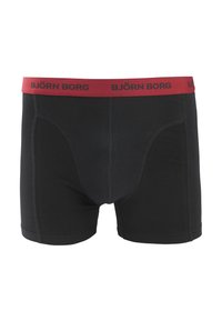 Zwarte boxershorts met een rode tailleband met daarop "BJÖRN BORG" in zwarte tekst. Gemaakt van zacht, rekbaar materiaal met een aansluitende pasvorm.