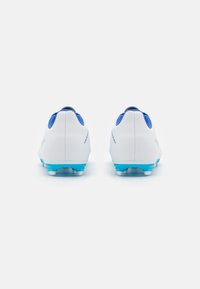 Pair of white and blue soccer cleats viewed from the back, showing blue studs and blue inner lining on a white background.