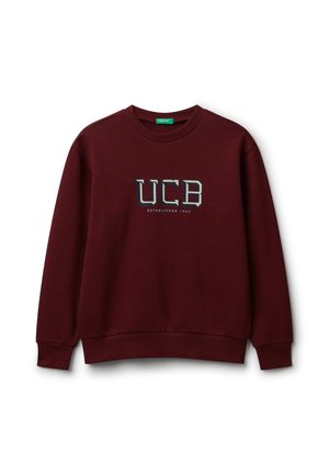 Felpa girocollo color marrone scuro con polsini e orlo a coste, che presenta il testo "UCB Fondato nel 1965" centrato sul petto.