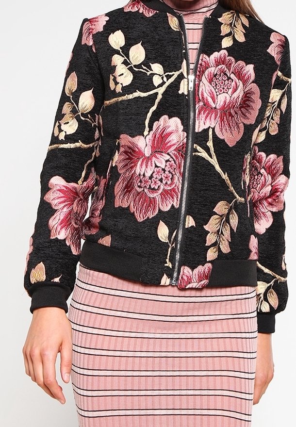 Černá bomber bunda s růžovou květinovou výšivkou, předním zipem a žebrovanými manžetami. Kombinováno s růžovými pruhovanými šaty.