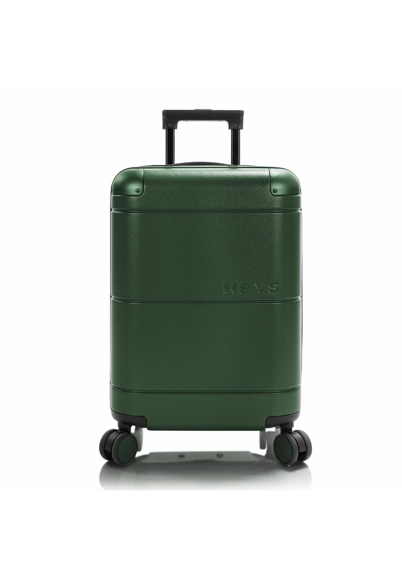 Valigia rigida di colore verde scuro, con texture liscia e finitura lucida. Presenta due ruote nere e un manico estraibile. Logo del marchio visibile.