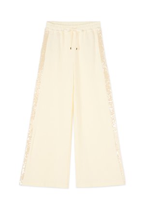 Kremowe spodnie o szerokich nogawkach z elastycznym pasem, sznurkiem do wiązania oraz paskami z cekinów biegnącymi po obu stronach.
