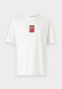 Hvid bomulds t-shirt med korte ærmer, prydet med et lille rødt og sort 7UP-logo på fronten. Klassisk crew neck design.