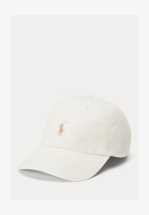 White cotton baseball cap with a curved brim, featuring a small beige embroidered logo on the front and six ventilation eyelets.