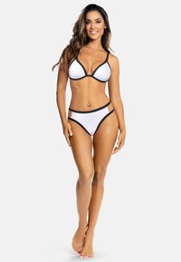 Biały zestaw bikini z teksturowanym trójkątnym biustonoszem z czarnym wykończeniem oraz pasującymi, wysoko wyciętymi majtkami z bocznymi wycięciami.