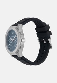 Roostevaba terasest kell sinise sihiga, kroonograafifunktsioon, must kummirihm ja hõbedased detailid. Ruudukujuline korpus.