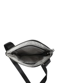 Borsa a tracolla nera con una texture liscia, chiusura con zip e un ampio interno con una fodera a fantasia e una tasca aggiuntiva.