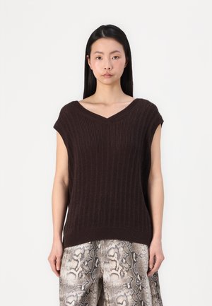 Brown knitted top with a V-neck and short sleeves. Features vertical ribbing texture, worn over patterned snake-print trousers.
