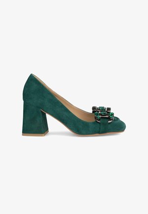 Escarpin à talon haut en daim bleu sarcelle avec un talon épais. Présente une décoration en bijoux noirs et verts sur l'avant. Doublure intérieure lisse.