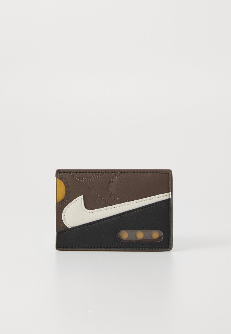 Brown leather wallet featuring white and black accents, a yellow detail, and three circular cutouts for card visibility.