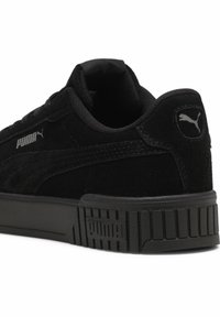 Schwarze Wildledersneaker mit strukturiertem Finish, ausgestattet mit Gummisohle, gepolstertem Schaft und silbernem Puma-Logo an der Seite und Rückseite.