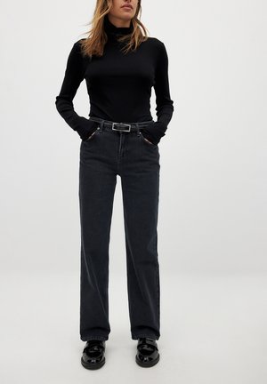 Black ribbed turtleneck, high-waisted dark denim pants, wide leg, and glossy black shoes. Simple design with classic, versatile details.