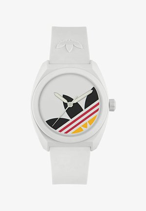 Biely silikónový remienok hodinkového ciferníka s veľkým guľatým tvarom, ktorý má sivé pozadie, čierne akcentové tvary a červené a žlté dizajnové prvky.