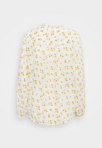 Blouse blanche à motif floral jaune, manches longues, encolure froncée et détail plissé à l'arrière. Tissu léger avec une texture douce.