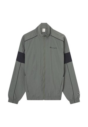 Graue Windjacke mit schwarzen Akzenten, elastischen Bündchen und Reißverschluss vorne. Mit Champion-Logo auf der Brust und dem Ärmel. Leichtes Material.