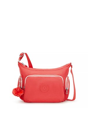 Borsa a tracolla corallo con cinturino regolabile, tasca frontale con zip, tasca laterale e un piccolo portachiavi a forma di scimmietta in peluche attaccato.