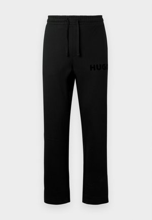 Black sweatpants with an elastic waistband, drawstring, and a small, embossed "HUGO" logo on the left side. Smooth texture, straight cut.