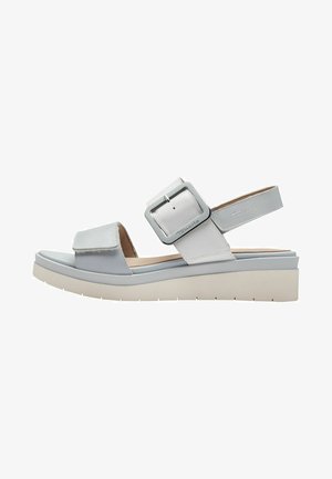 Světle modré a bílé sandály s kulatou špičkou, širokým páskem, nastavitelnou sponou a klínovou podrážkou v kontrastní krémové barvě.