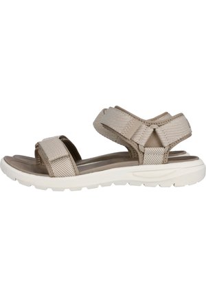 Sandale beige à bout ouvert avec des brides réglables à la cheville et aux orteils, une semelle intérieure rembourrée et une semelle en caoutchouc blanche texturée.