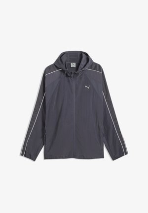 Dunkelgraue Puma Windjacke mit Kapuze, durchgehendem Frontreißverschluss, weißen Paspeln an den Ärmeln und Puma-Logo auf der linken Brust.